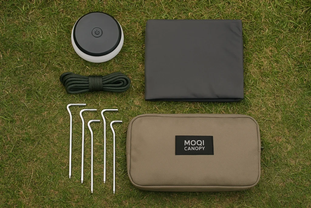A group shot of camping accessories including LED light, floor mat, storage pockets